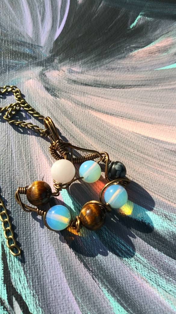 Orbital Thoughts. Opalite, rose quartz, snowflake jasper and tigers eye necklace. Made by Eyesthatburnthemind.