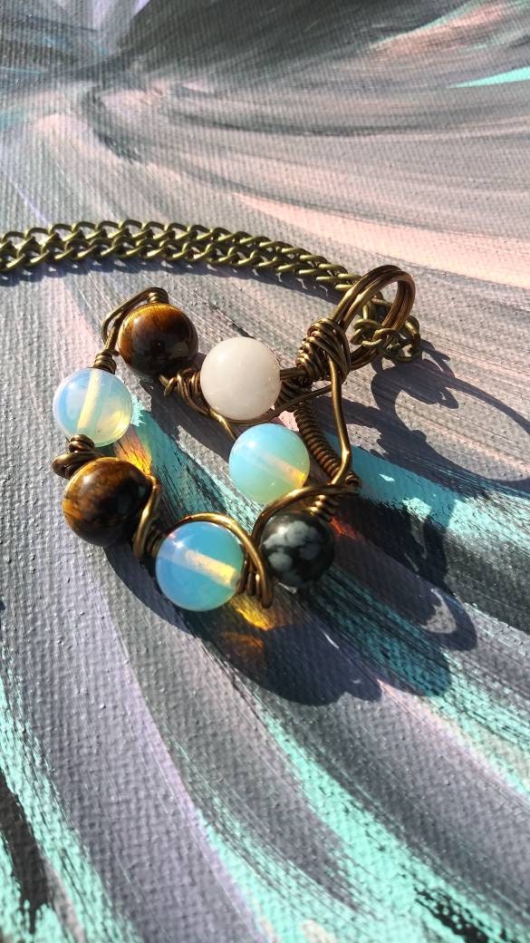 Orbital Thoughts. Opalite, rose quartz, snowflake jasper and tigers eye necklace. Made by Eyesthatburnthemind.