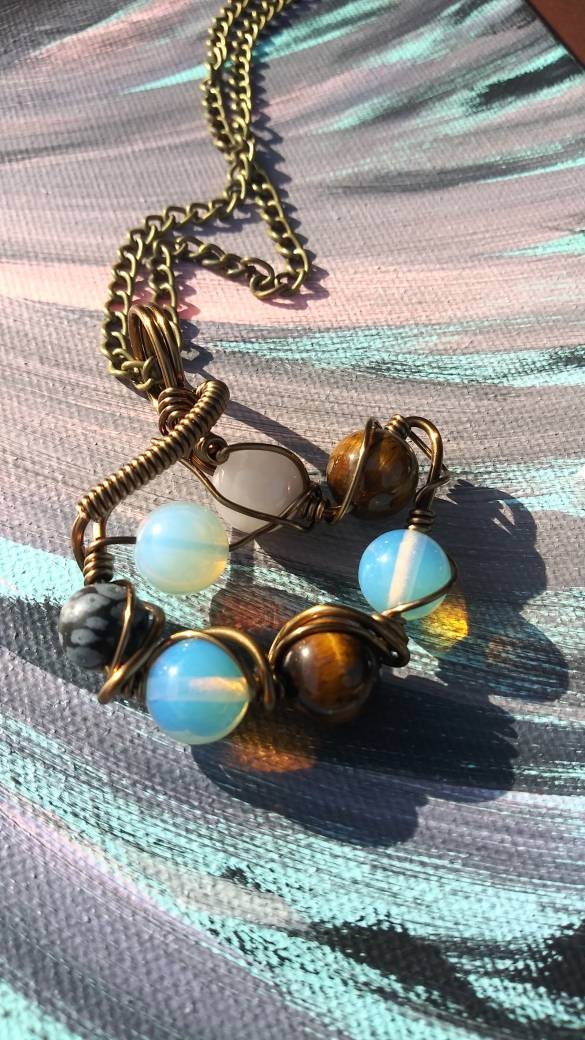 Orbital Thoughts. Opalite, rose quartz, snowflake jasper and tigers eye necklace. Made by Eyesthatburnthemind.