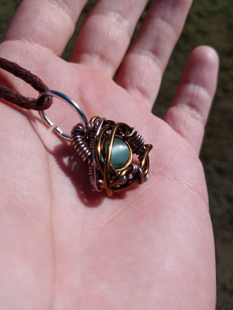 Nebulous. Cats Eye glass necklace. Made by Eyesthatburnthemind.