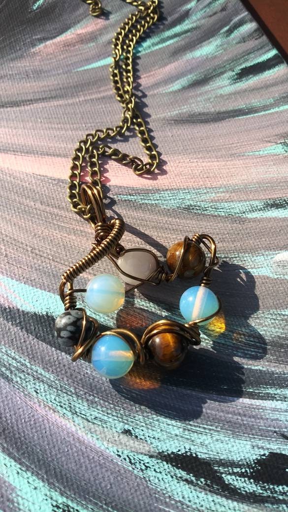 Orbital Thoughts. Opalite, rose quartz, snowflake jasper and tigers eye necklace. Made by Eyesthatburnthemind.