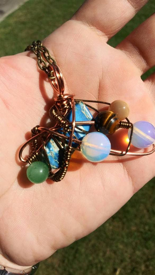 Broken Wing. Spiral. Opalite, adventurine, mother of pearl and tigers eye necklace. Made by Eyesthatburnthemind.