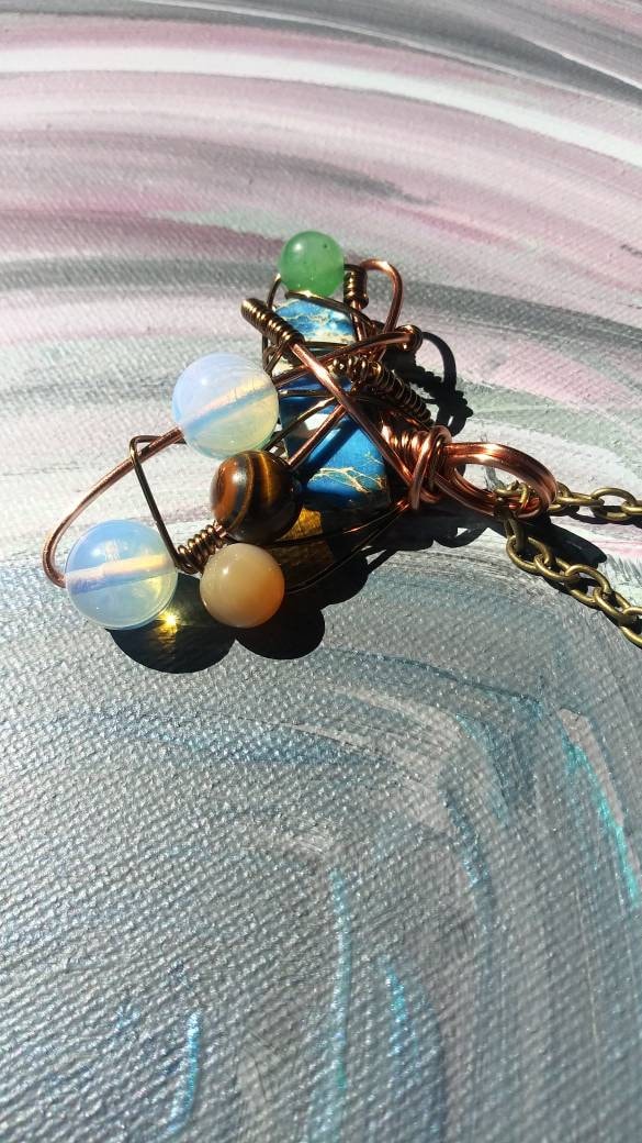 Broken Wing. Spiral. Opalite, adventurine, mother of pearl and tigers eye necklace. Made by Eyesthatburnthemind.