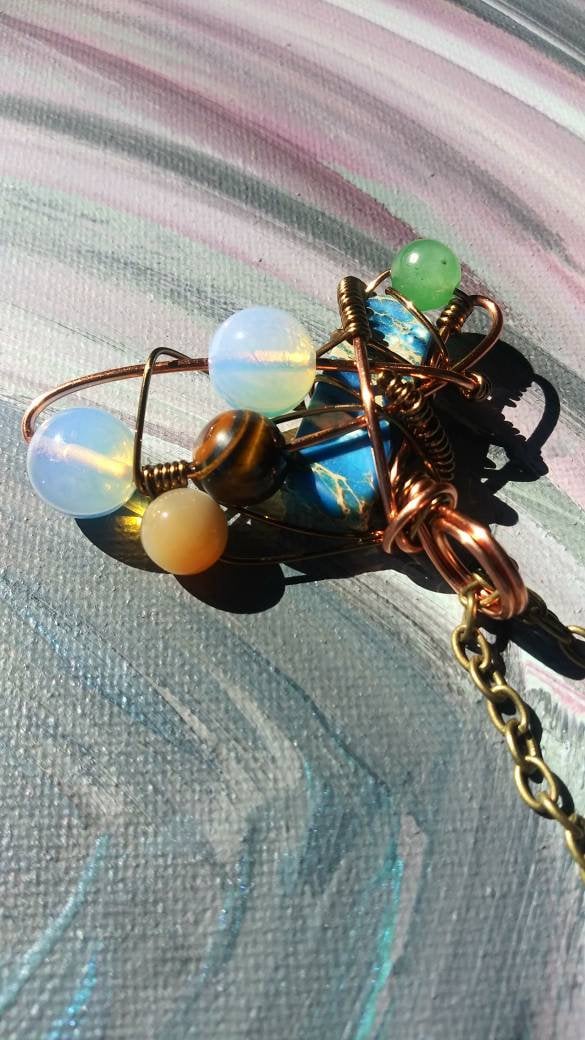 Broken Wing. Spiral. Opalite, adventurine, mother of pearl and tigers eye necklace. Made by Eyesthatburnthemind.