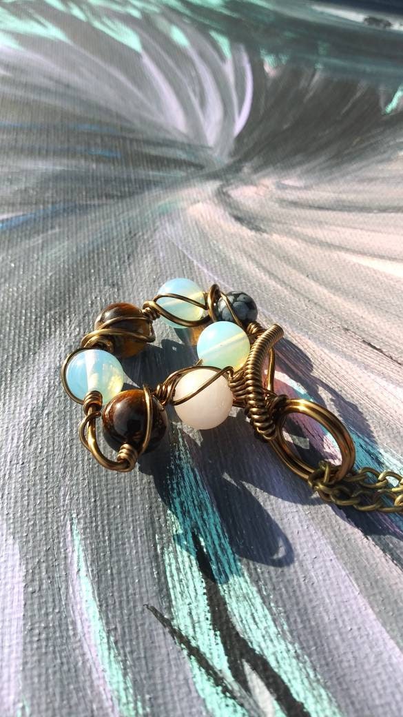 Orbital Thoughts. Opalite, rose quartz, snowflake jasper and tigers eye necklace. Made by Eyesthatburnthemind.