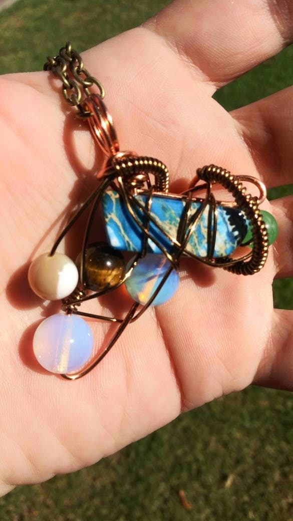 Broken Wing. Spiral. Opalite, adventurine, mother of pearl and tigers eye necklace. Made by Eyesthatburnthemind.
