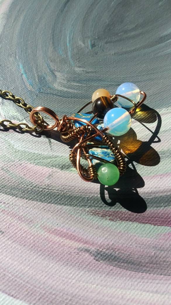 Broken Wing. Spiral. Opalite, adventurine, mother of pearl and tigers eye necklace. Made by Eyesthatburnthemind.