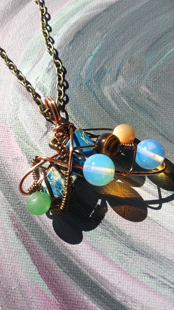 Broken Wing. Spiral. Opalite, adventurine, mother of pearl and tigers eye necklace. Made by Eyesthatburnthemind.